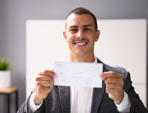 Businessman holding a check.